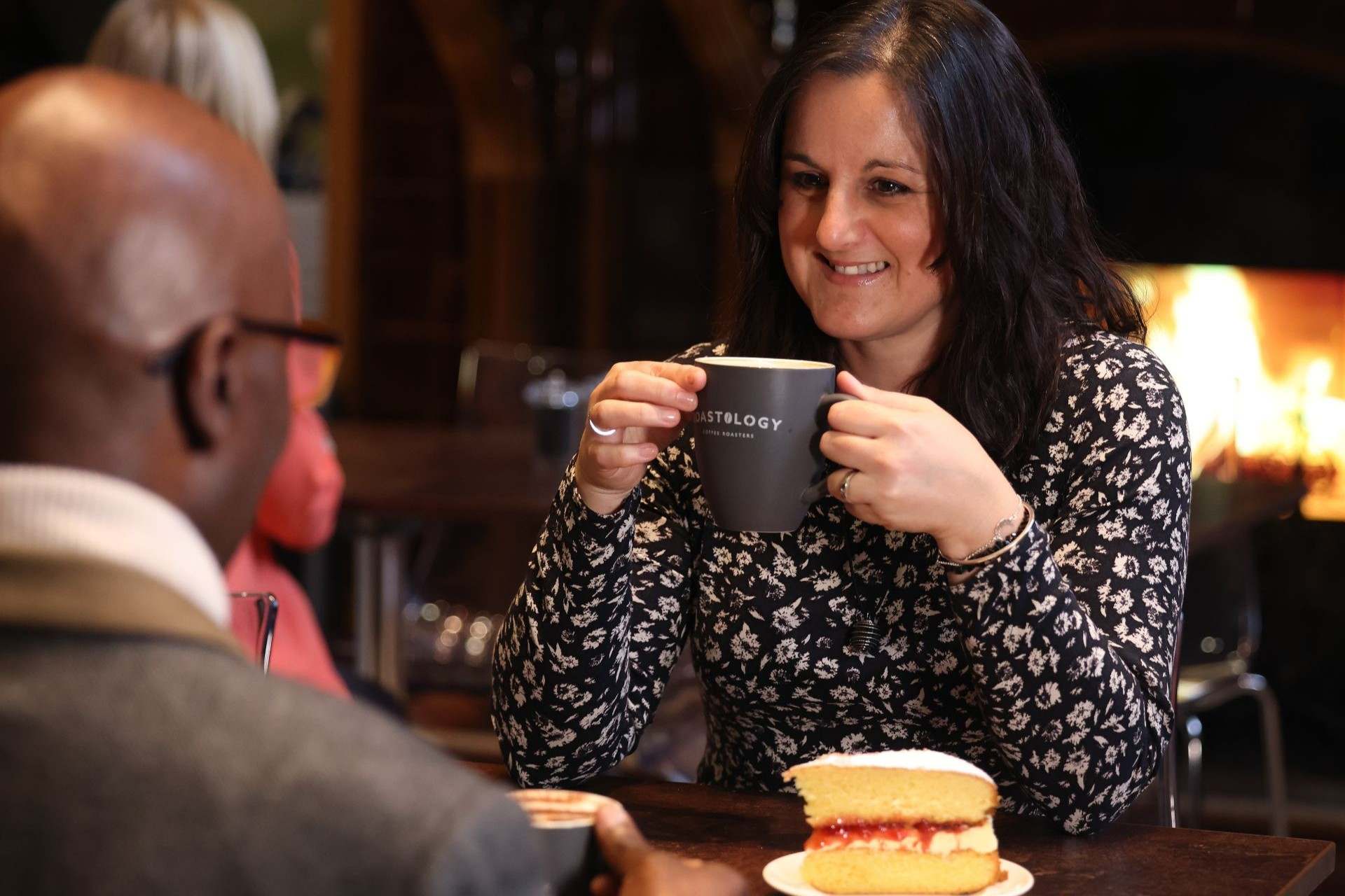 A woman drinks coffee and enjoys slice of cake at the Waterhouse Café at the Victoria Gallery & Museum