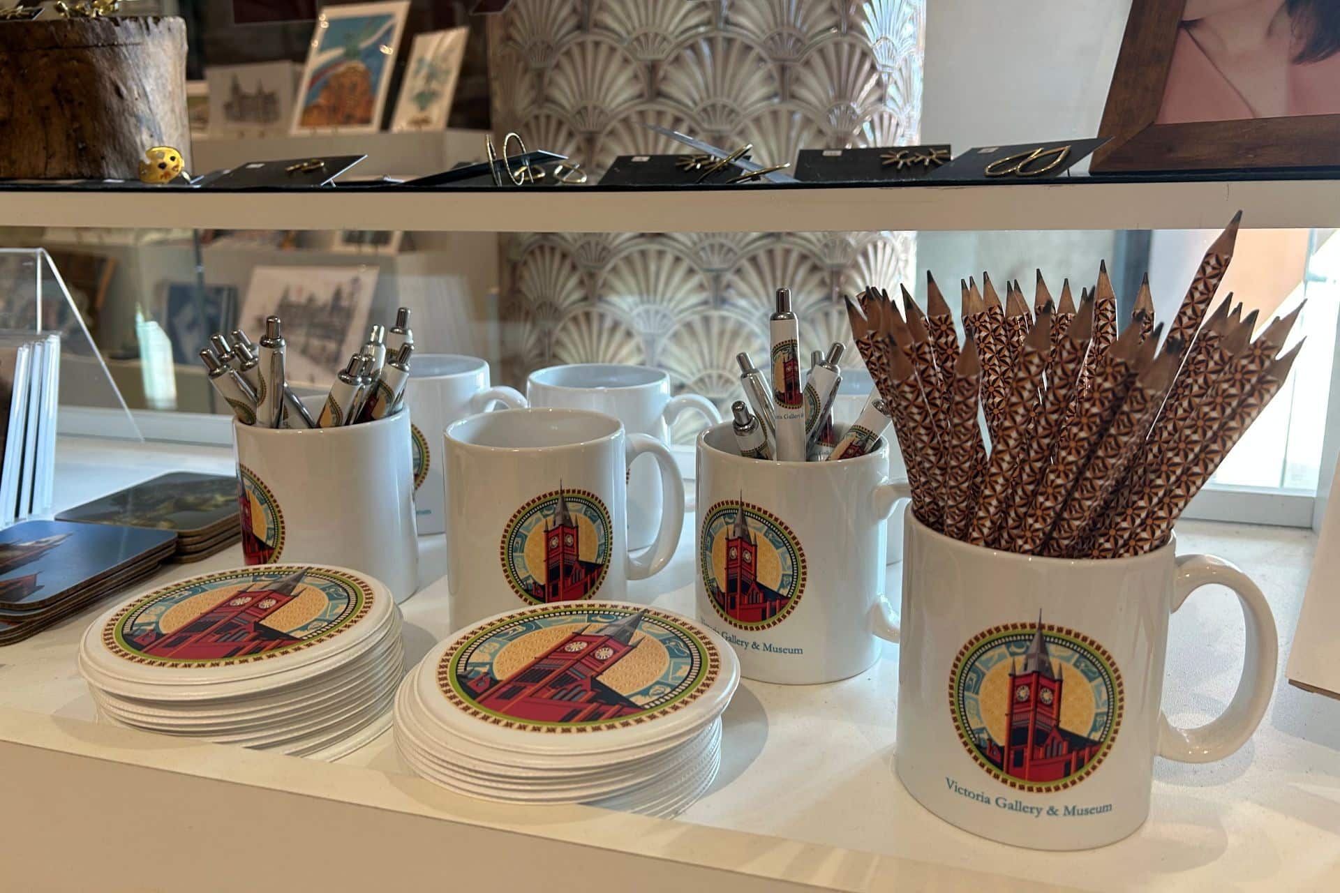 Merchandise including mugs and pens you can find at the VG&M shop