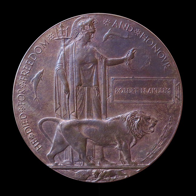 WW1 Memorial plaque (or 'death penny') designed by Edward Carter Preston. Photo by Gary Blakeley, published under Creative Commons licence.