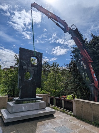 Sculpture lowered into final position back at the library