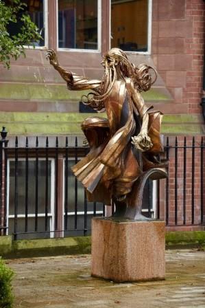 sculpture of a prophet from the old testament, robes flowing in a breeze