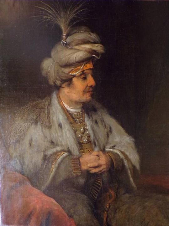 A man dressed in an outfit that resembles those of senior leaders of the Ottoman Empire 
