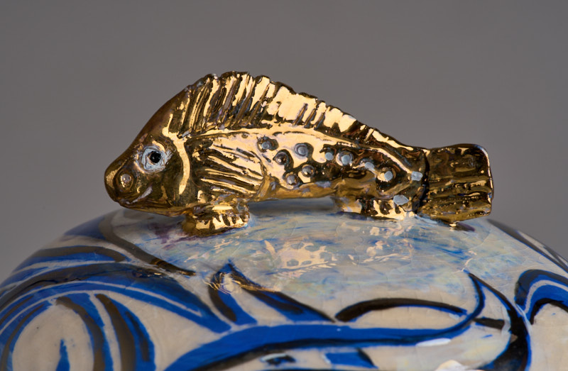 Golden sea bass atop a lidded vase by Julia Carter Preston. By kind permission of the Liverpool Hope Carter Preston Foundation.