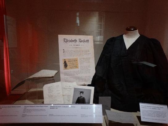 Elizabeth Beckett's Graduation gown, photogaph and report cards from university