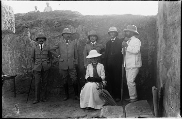 Photograph of a group visiting the excavations at Meroë, including (from left) Midwinter Bey, Director of Sudan Railways; General Herbert Kitchener, 1st Earl Kitchener; General Sir Francis Reginald Wingate, 1st Baronet, Governor-General of Sudan; Professor Archibald Sayce; John Garstang; and Lady Catherine 