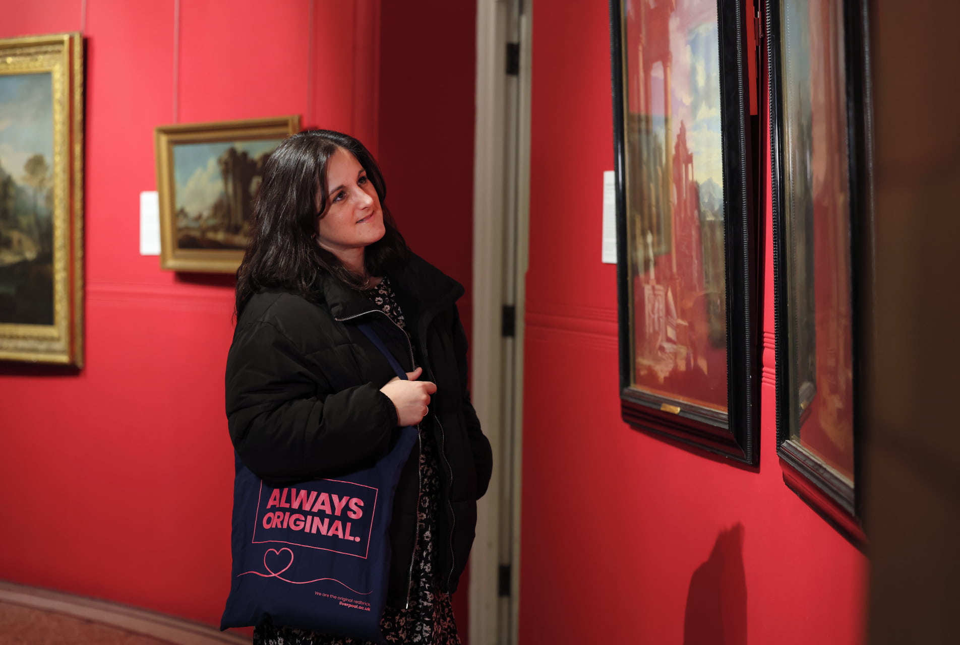 A visitor observes a painting on the wall at the Victoria Museum & Gallery