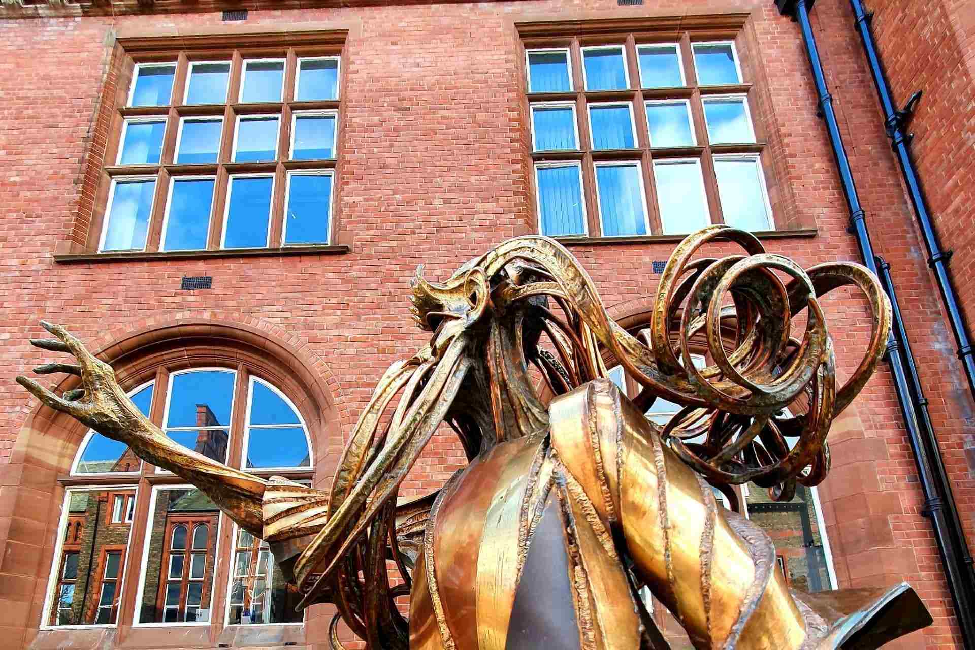 A bronze scultpture of a bearded man featured on the campus sculpture tour