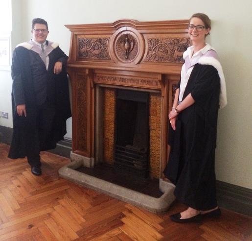 Two graduates next to the VG&M fireplace, first floor